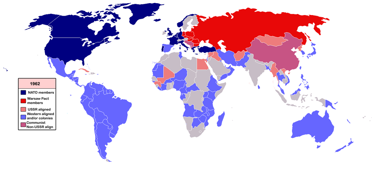 World map from 1962 showing Cold War alliance blocs. Dark blue = NATO members including the United States, Canada, Western Europe, and Australia. Red = Warsaw Pact members including the USSR and Eastern Europe. Pink = USSR-aligned states. Light blue = Western-aligned nations and or colonies. Purple/mauve = Communist Non-USSR aligned nations including China. Gray = neutral or unaffiliated nations.